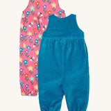 Frugi kids reversible helen dungarees in boat blue/fun flowers. A 100% GOTS organic cotton dungaree with a blue corduroy a pink reversible side with playful flower prints and handy back pocket. Features popper fasteners on the shoulder straps and cuffed  ankles.