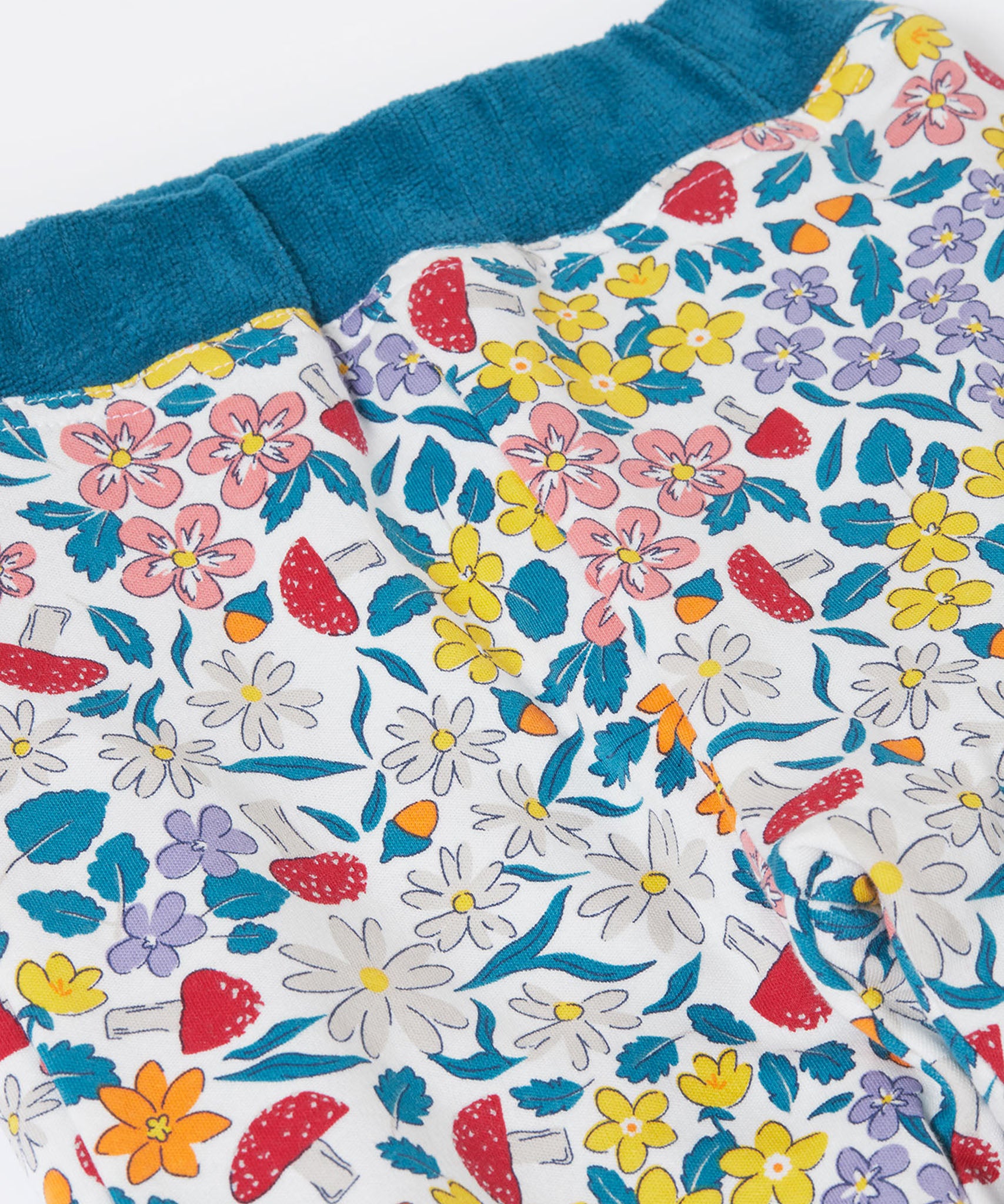 A close up of the floral design on the The back of the Frugi Poppy Reversible Pull Ups - Blue / Wild Woods available at Babipur