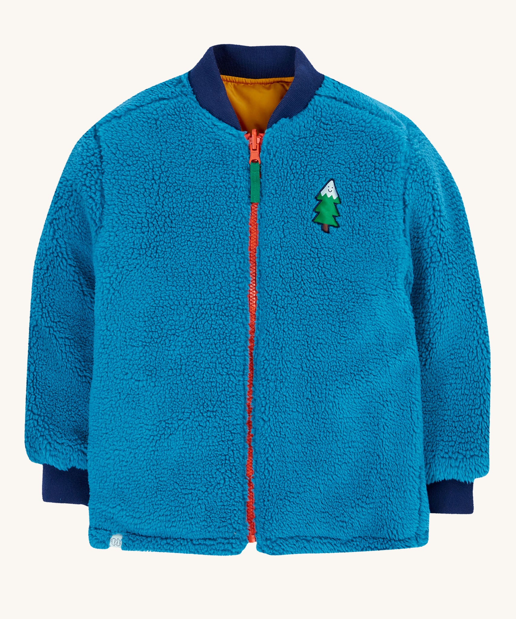Frugi robin reversible quilted jacket in yellow gold with boat blue fleece. The jacket is shown with the blue coloured fleece on the outside.