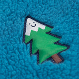 A super close up detail shot of the tree badge that is on the chest of the blue fleece side of the frugi robin-quilted-lined-reversible-jacket-yellow-gold