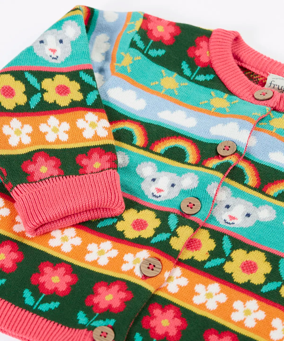 Close up of the Frugi Robyn fairisle cardigan with a mouse Fair Isle design featuring flowers, rainbows, clouds and suns. 