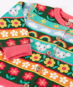 Close up of the Frugi Robyn fairisle cardigan with a mouse Fair Isle design featuring flowers, rainbows, clouds and suns. 
