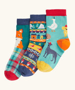 Frugi rock my socks 3 pack paw-ty time pet party organic cotton kids socks. One blue pair covered in pets with party hats, one fair isle design, one festive check with red fox.