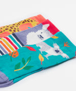 Close up of the Frugi kids rock my socks 3 pack, zoologist. Showing all 3 bright fun Frugi zoologist socks including a grey koala, white llama and a giraffe sock on organic cotton fabric