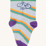 The bicycle design organic cotton kids socks from the Frugi rock my socks adventure socks multipack. The design features a navy blue bicycle with a multi-coloured stripe on a grey marl background.