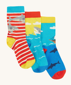 Frugi Rock My Socks 3 Pack laid flat, in the High Seas print. Featuring a bright striped pair, a blue pirate ship pair, and a brilliant shark pair.