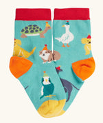Paw-ty time, pet party design socks from the Frugi rock my socks 3 pack paw-ty time pet party organic cotton kids socks. Blue kids socks covered in pets wearing party hats.