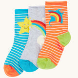 Frugi pack of three bamboo children's socks with roll tops. One blue striped pair with a yellow star, one plain grey with a rainbow and sun and one orange striped pair with a ray. 