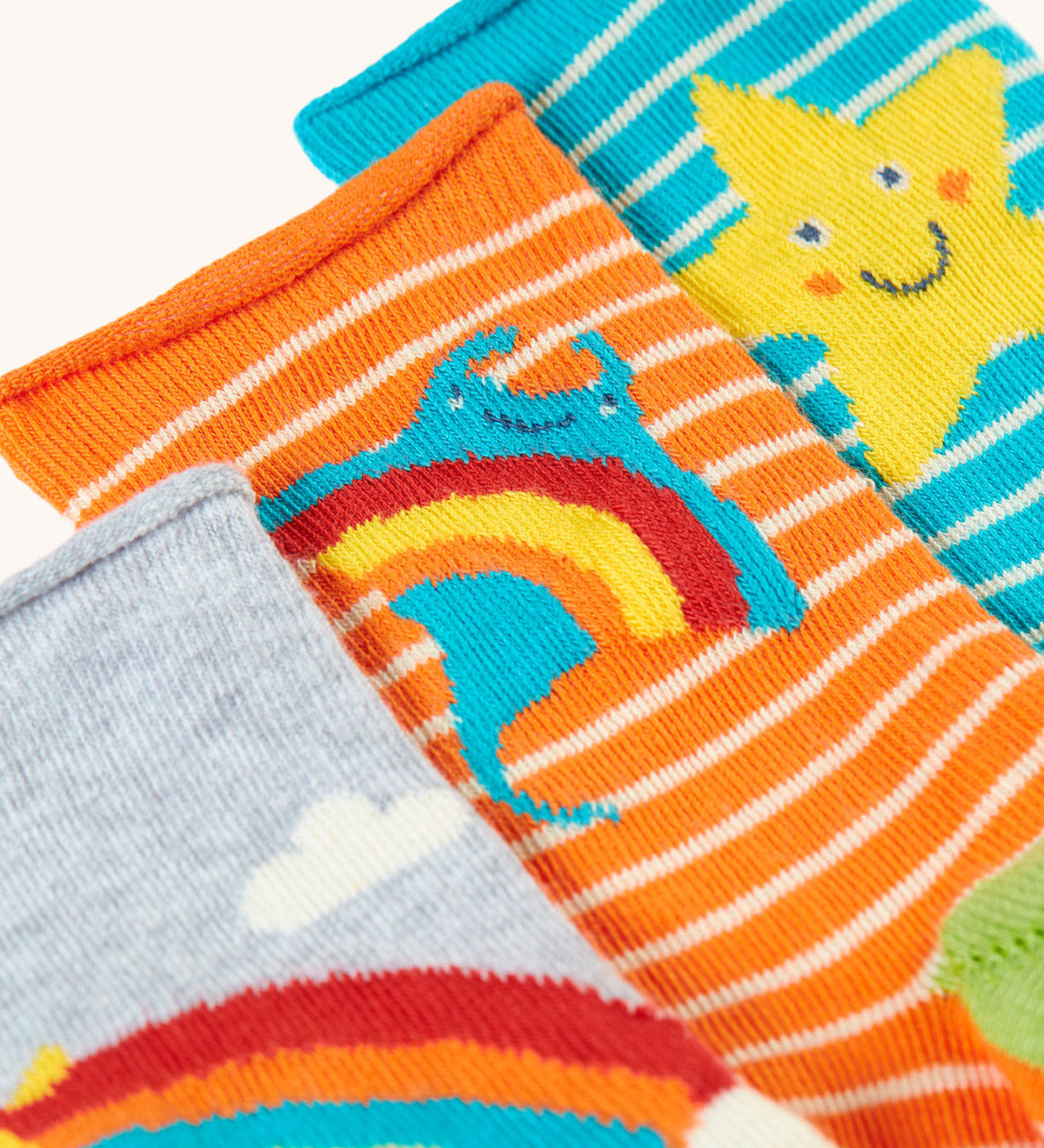 A close up of the orange striped ray socks from the Frugi pack of three bamboo children's socks with roll tops. 