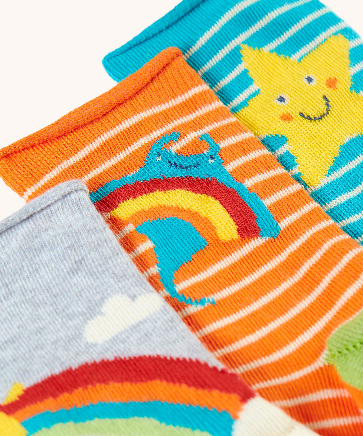 A close up of the orange striped ray socks from the Frugi pack of three bamboo children's socks with roll tops. 