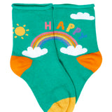 Green kids socks with a rainbow design and the word happy written above from the Frugi little roly bamboo socks in a 3 pack with rainbow designs. 