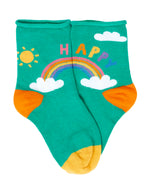 Green kids socks with a rainbow design and the word happy written above from the Frugi little roly bamboo socks in a 3 pack with rainbow designs. 