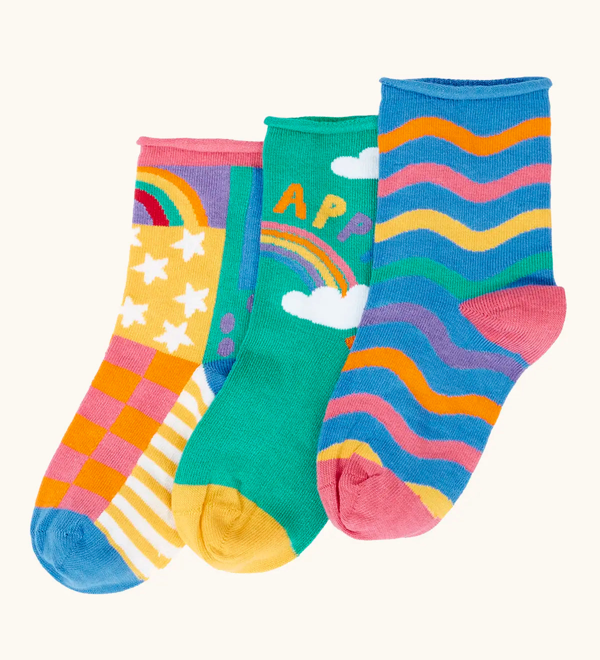 Frugi little roly bamboo socks in a 3 pack with rainbow designs. Rainbow wave stripe pair, green with happy rainbow pair and a patchwork pattern pair.