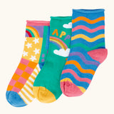 Frugi little roly bamboo socks in a 3 pack with rainbow designs. Rainbow wave stripe pair, green with happy rainbow pair and a patchwork pattern pair.