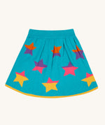 The Frugi Rory Reversible organic cotton kids Skirt with a Rainbow Stars design shown on the turquoise blue side with multicolored stars. 