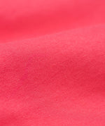 A close up of the Frugi kids libby leggings in rose showing the knit detail on bright pink organic cotton fabric.