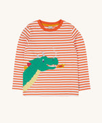 Frugi Salamander Stripe Dragon Discovery Circular Top. This orange and white striped top has a green coloured dragon applique detail on the front. This top is a part of a wide range of organic cotton clothing for children available here at Babipur. 
