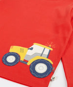 Frugi GOTS organic cotton red long sleeve top showing a yellow tractor applique on the bottom 