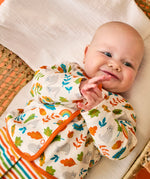 Baby wearing the striped babygrow and wild cats cardigan from the Frugi scrumptious babygrow gift set.