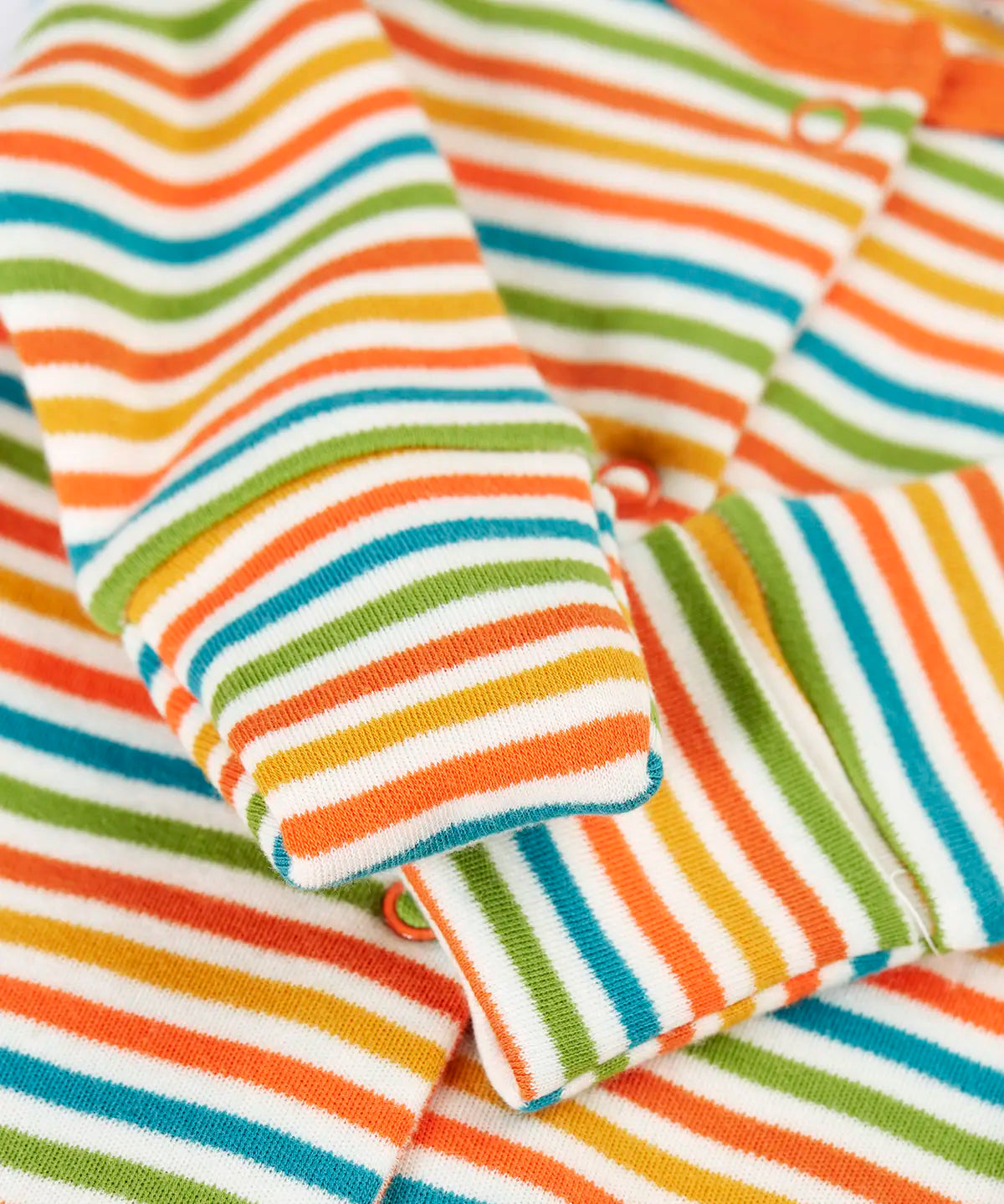 Close up of the fold over mitt cuffs on the stripe sleepsuit from the Frugi scrumptious babygrow gift set.