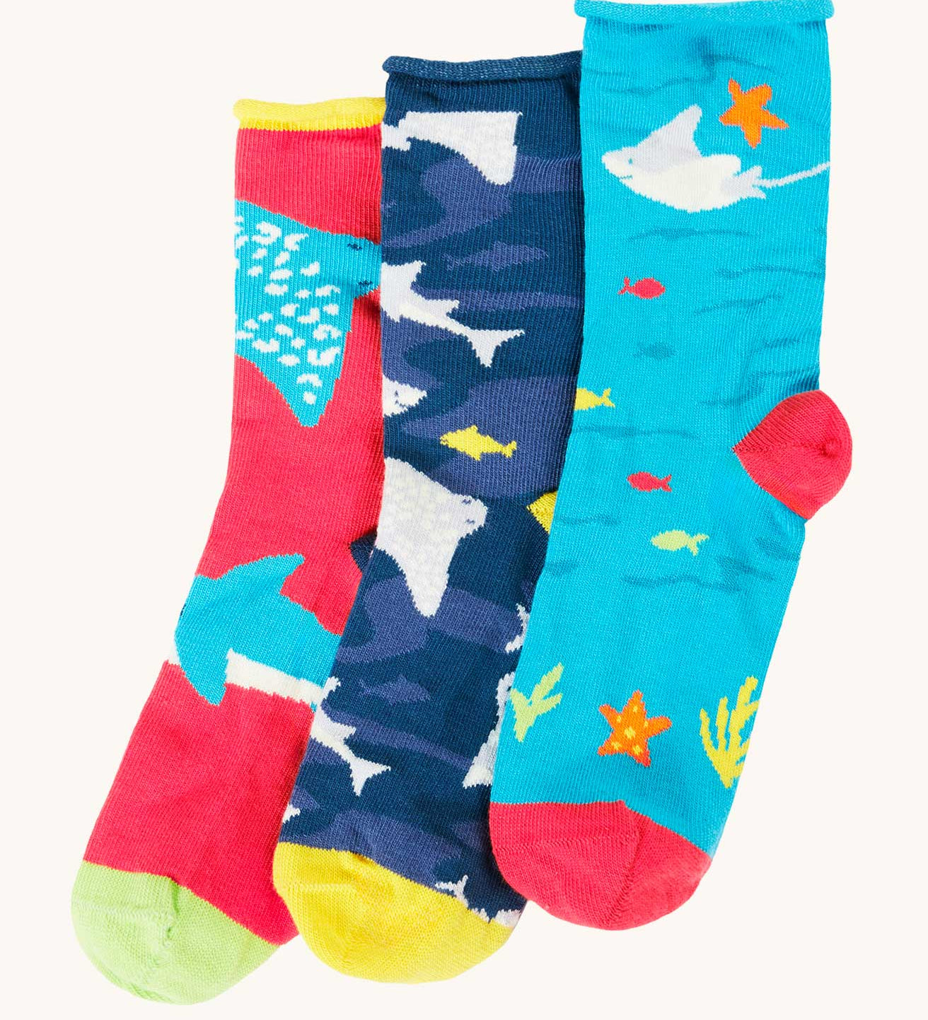Frugi pack of three sealife themed bamboo children's socks with roll tops. One blue pair with sting rays, one navy blue with sharks and one pink with rays and sharks.
