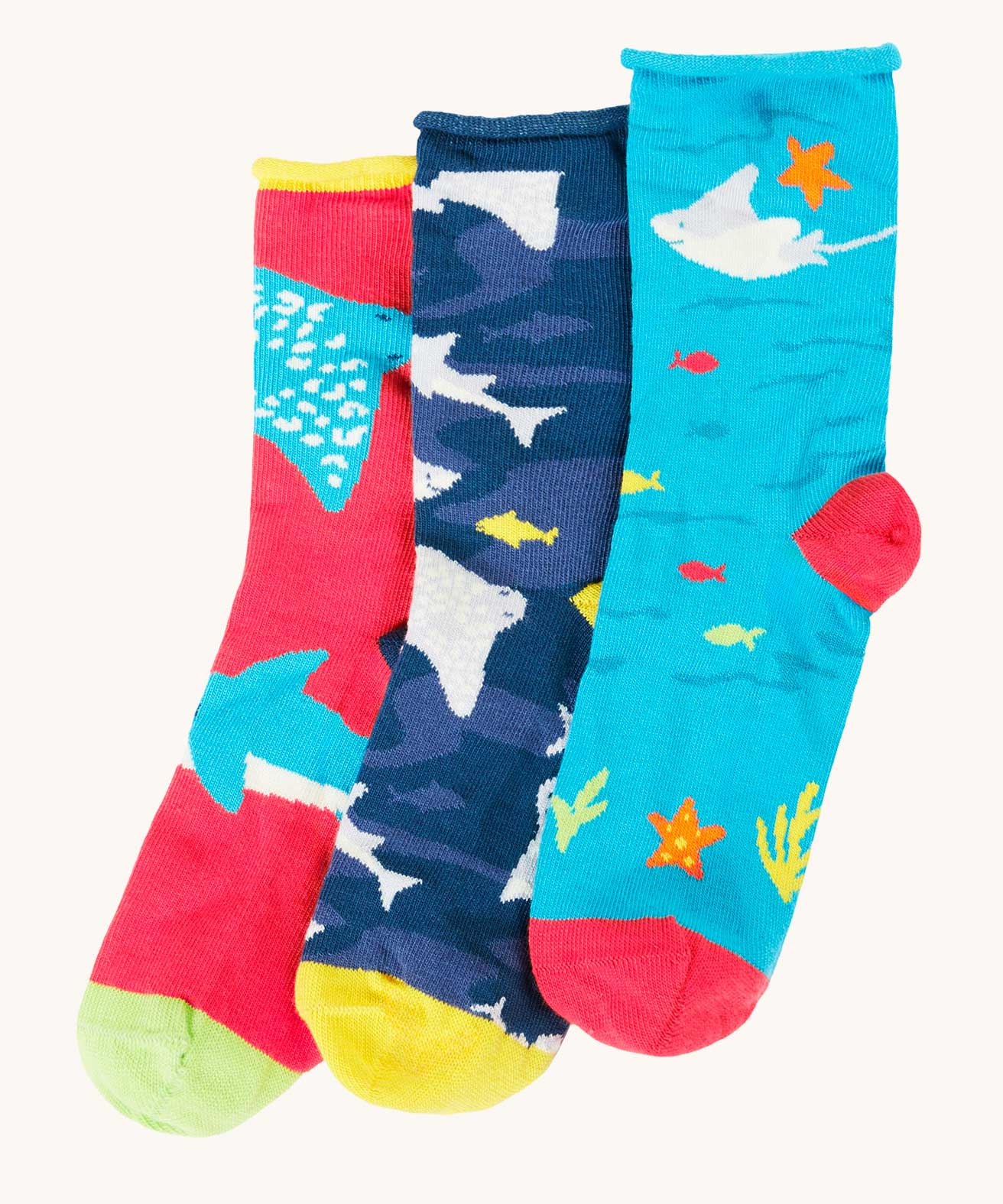 Frugi pack of three sealife themed bamboo children's socks with roll tops. One blue pair with sting rays, one navy blue with sharks and one pink with rays and sharks.