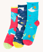 Frugi pack of three sealife themed bamboo children's socks with roll tops. One blue pair with sting rays, one navy blue with sharks and one pink with rays and sharks.
