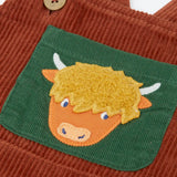 Frugi brown rust organic cotton cord dungaree laid flat showing close up of a green chest pocket with highland cow applique on the front