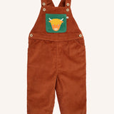 Frugi sebby brown rust organic cotton cord dungaree with a green chest pocket featuring a highland cow applique.
