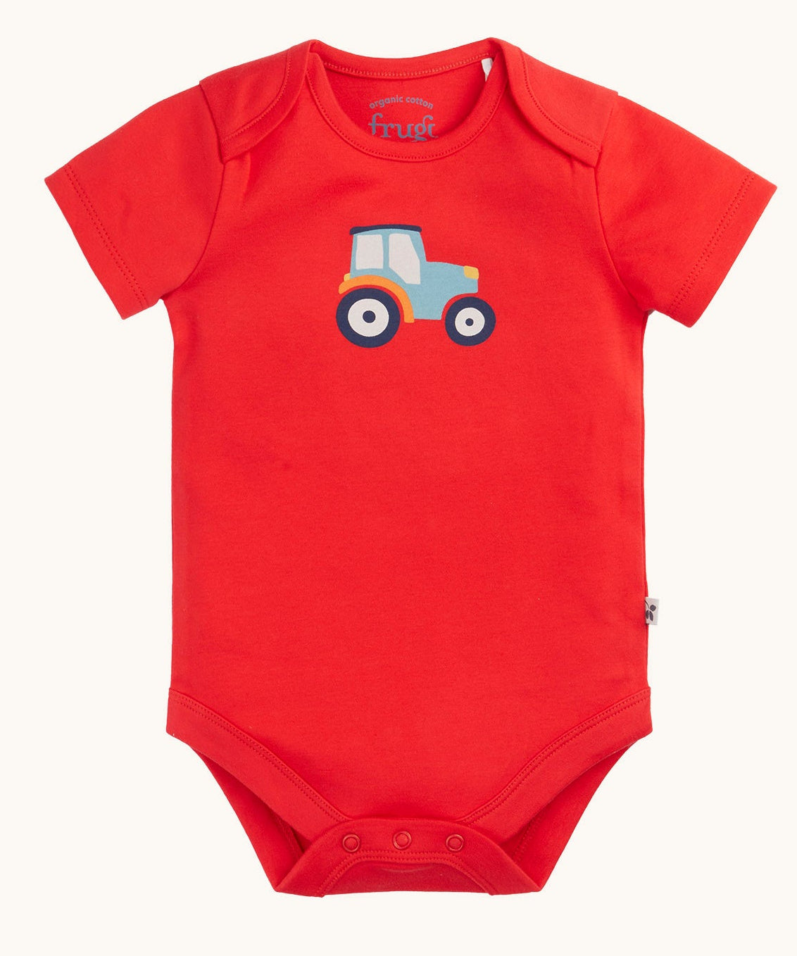 The red vest with blue tractor on from the A two pack of Frugi short sleeve baby vests. 
