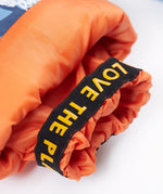 A close up of the Frugi penguin waddle snow and ski salopettes showing the orange snow cuff detail 