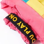 A close up of the Frugi rainbow check snow and ski salopettes showing the pink snow cuff detail 