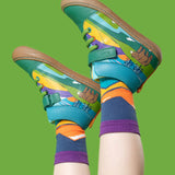 A child wearing the Frugi Sky Stretch children's leather Lace Boot with a holly green bear design with Frugi organic cotton socks featuring a mountian outline design. Check out our range of kids shoes and socks here at Babipur.