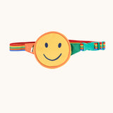 Frugi happy smiley face children's belt bag. A circular shaped yellow back decorated with a smiley face on a rainbow coloured strap with claps closure. 