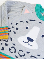 Close up Frugi snow leopard organic cotton character knit jumper with 3d ears, green neck trim and rainbow arm cuffs and hemline. 