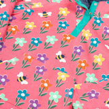 A close up of the Frugi tulip pink kids snuggle fleece with a fun flowers design. 