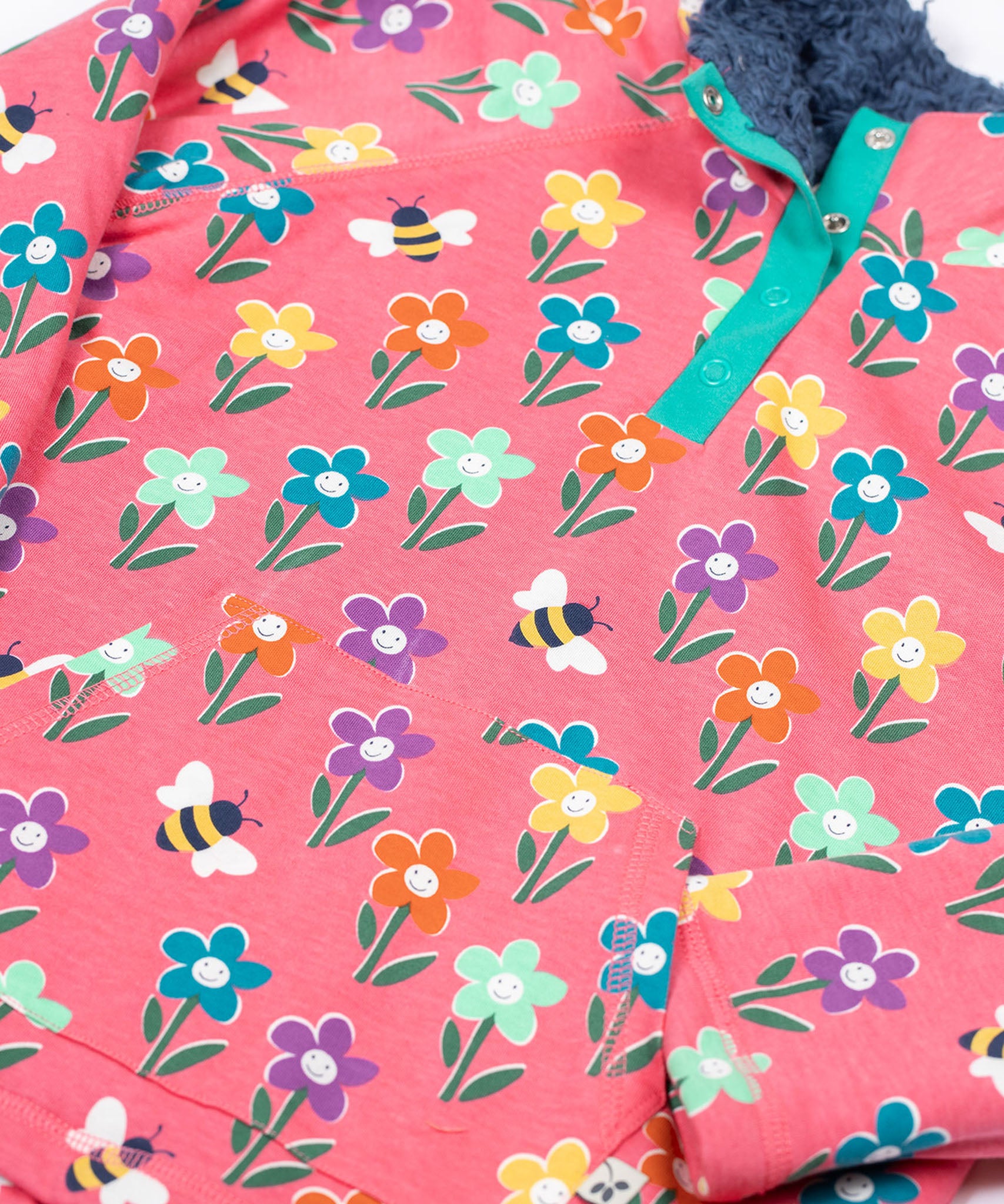 A close up of the Frugi tulip pink kids snuggle fleece with a fun flowers design. 