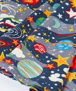 Close up of the skirt on the Frugi Sofia organic cotton skater dress in navy with an all over explore the stars print. 