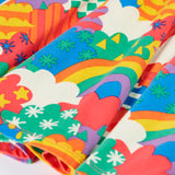 Close up of the hemline on the skirt of the Frugi Sofia organic cotton long sleeved skater dress in a multi-coloured fun frenzy print