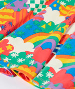 Close up of the hemline on the skirt of the Frugi Sofia organic cotton long sleeved skater dress in a multi-coloured fun frenzy print