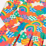 Close up of the Frugi Sofia organic cotton long sleeved skater dress in a multi-coloured fun frenzy print. 