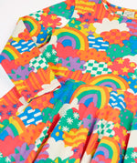 Close up of the Frugi Sofia organic cotton long sleeved skater dress in a multi-coloured fun frenzy print. 