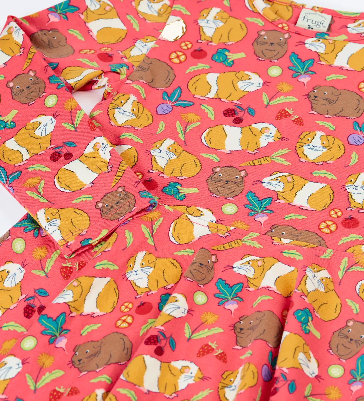 Close up of the Frugi Sofia skater dress in pink with an all over guinea pig muddle print. 