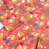 Close up of the Frugi Sofia skater dress in pink with an all over guinea pig muddle print. 