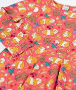 Close up of the Frugi Sofia skater dress in pink with an all over guinea pig muddle print. 