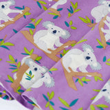 Close up of the skirt on the Frugi Sofia organic cotton skater dress in purple with an all over koala cuddles print.