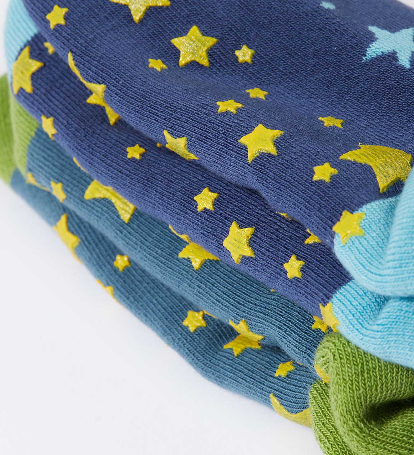 A close up of the green srippy stars on the bottom of the Frugi Festive Reindeer Great Organic Cotton Grippy Socks for Kids 2 Pack. These socks are part of a wide range of organic cotton clothing for children available here at Babipur. 