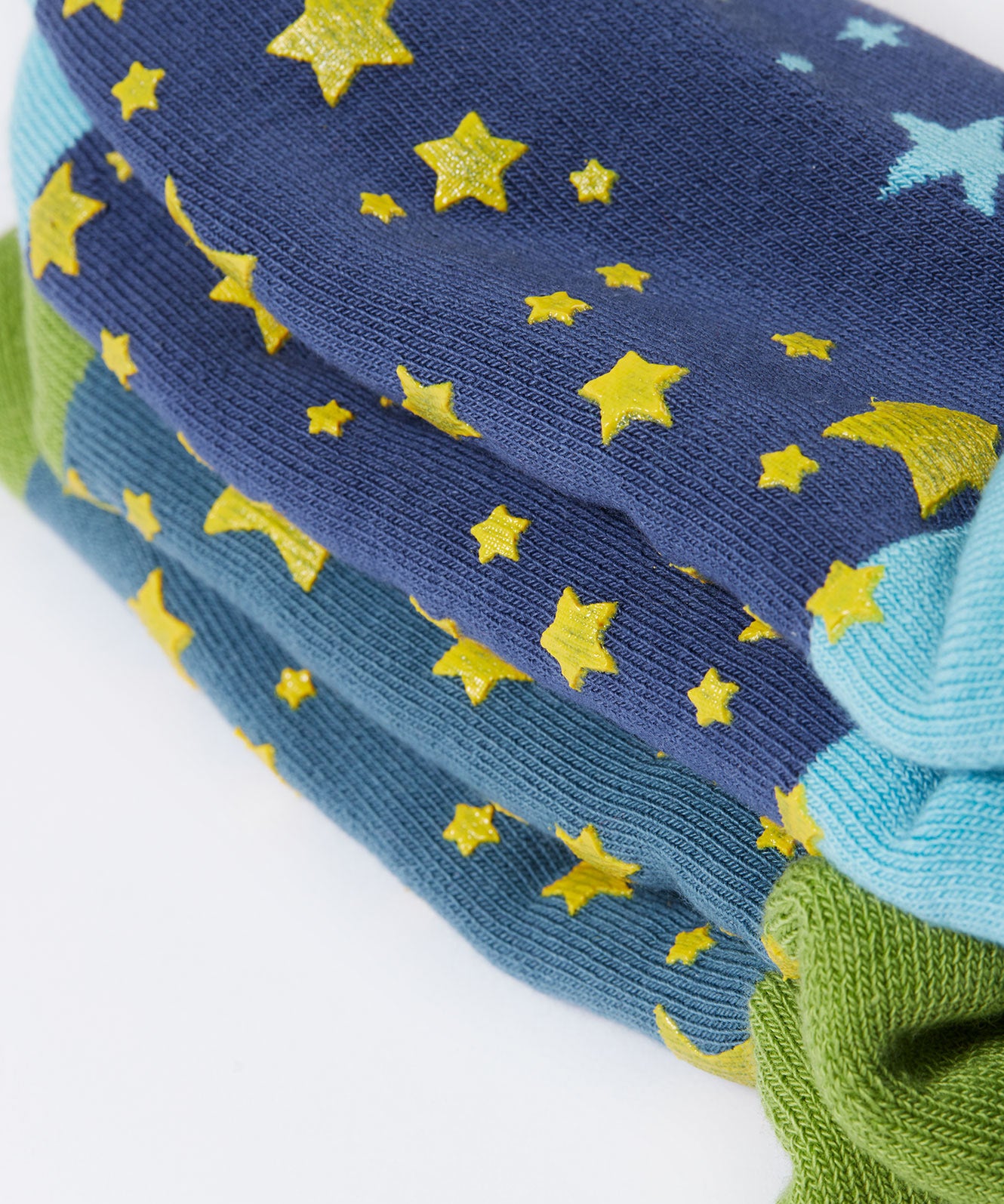 A close up of the green srippy stars on the bottom of the Frugi Festive Reindeer Great Organic Cotton Grippy Socks for Kids 2 Pack. These socks are part of a wide range of organic cotton clothing for children available here at Babipur. 
