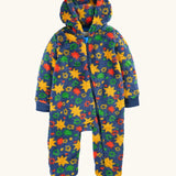A frugi hooded one-piece baby jumpsuit in a fuzzy fleece material, featuring a vibrant multicolor star pattern on a navy blue base. The jumpsuit has a front zipper, ribbed cuffs, and ribbed ankle cuffs.