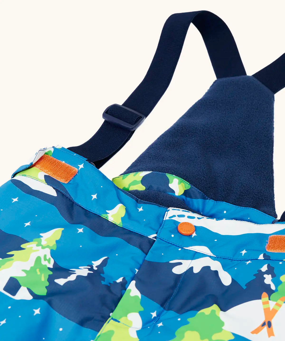 Frugi kids snow and ski salopettes in starry slopes showing the removable  dark navy shoulder strap matching fleece back panel 